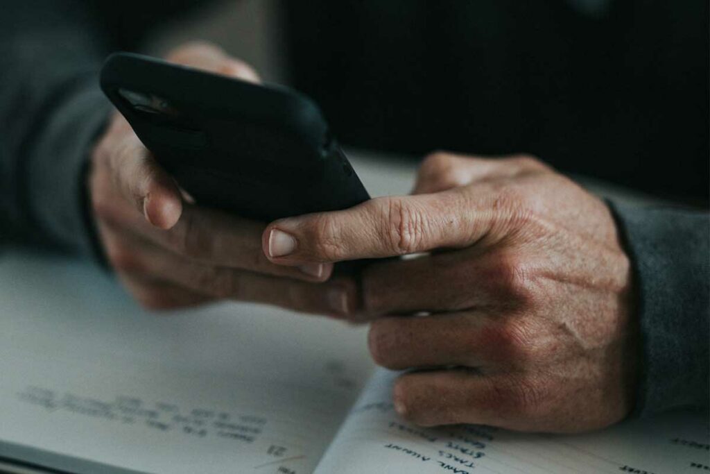 men using a phone to contact Helget Gas